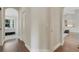 Hallway view showcasing wood floors, access to the bedroom and arched doorway to the kitchen at 8102 Waterview Blvd, Lakewood Ranch, FL 34202
