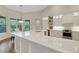 Kitchen with large island, stainless steel appliances, white cabinets, and a view to the dining area at 8102 Waterview Blvd, Lakewood Ranch, FL 34202