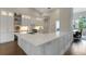 Kitchen with white cabinets, stainless steel appliances, hardwood floors, and a large island at 8102 Waterview Blvd, Lakewood Ranch, FL 34202