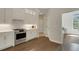 Bright and modern kitchen featuring white cabinets, stainless steel appliances, and wood flooring at 8102 Waterview Blvd, Lakewood Ranch, FL 34202