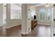 View of living room with hardwood floors, a TV on a media console, and doorway to dining room at 8102 Waterview Blvd, Lakewood Ranch, FL 34202