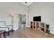 Bright living room featuring hardwood floors, French doors, a shelving unit and high ceilings at 8102 Waterview Blvd, Lakewood Ranch, FL 34202