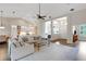 Spacious living area with open floor plan, modern lighting, and comfortable seating arrangement at 8102 Waterview Blvd, Lakewood Ranch, FL 34202