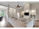 Spacious living room with tall ceilings, a ceiling fan, built-in shelves, and a comfortable sectional sofa at 8102 Waterview Blvd, Lakewood Ranch, FL 34202