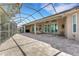 Spacious screened-in lanai with brick pavers, outdoor seating, and direct access to the home's interior at 8102 Waterview Blvd, Lakewood Ranch, FL 34202