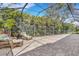 Expansive screened patio featuring brick pavers, seating, and views of the surrounding tropical landscape at 8102 Waterview Blvd, Lakewood Ranch, FL 34202