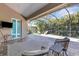 Spacious screened patio with comfortable seating and lush landscaping views at 8102 Waterview Blvd, Lakewood Ranch, FL 34202