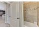 Bathroom with tiled tub, and decorative shower curtain at 8417 Karpeal Dr # 4, Sarasota, FL 34238