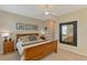 Neutral bedroom with a wooden bed frame and decorative wall mirror at 8417 Karpeal Dr # 4, Sarasota, FL 34238