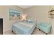 Cozy bedroom with neutral colored walls and an armchair at 8417 Karpeal Dr # 4, Sarasota, FL 34238