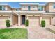 Two-story townhome with a one car garage, charming entrance, and well-maintained landscaping at 8417 Karpeal Dr # 4, Sarasota, FL 34238