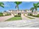 Inviting townhome community with well-manicured landscaping, brick driveway and attached garages at 8417 Karpeal Dr # 4, Sarasota, FL 34238