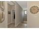 Upstairs hallway with tile flooring, neutral paint and decorative wall art at 8417 Karpeal Dr # 4, Sarasota, FL 34238