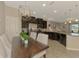 Open-concept kitchen with dark cabinetry, stainless appliances, and a view of the dining and living area at 8417 Karpeal Dr # 4, Sarasota, FL 34238
