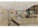 Spacious kitchen with a granite island, stainless steel appliances and open dining area at 8417 Karpeal Dr # 4, Sarasota, FL 34238