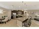 Spacious kitchen with dark wood cabinets, stainless steel appliances and a granite island with seating at 8417 Karpeal Dr # 4, Sarasota, FL 34238