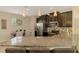 Modern kitchen with stainless steel appliances, granite countertops, and stylish pendant lights at 8417 Karpeal Dr # 4, Sarasota, FL 34238