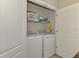 Convenient laundry room with white washer and dryer and ample shelf space for storage at 8417 Karpeal Dr # 4, Sarasota, FL 34238