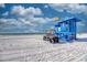 Picturesque beach scene featuring a blue lifeguard tower and a utility vehicle on white sand at 8417 Karpeal Dr # 4, Sarasota, FL 34238
