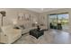 Bright living room with comfortable seating, stylish decor, and a view of the outdoor scenery at 8417 Karpeal Dr # 4, Sarasota, FL 34238