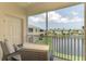 Relaxing screened patio seating area overlooking serene water view, perfect for enjoying the outdoors at 8417 Karpeal Dr # 4, Sarasota, FL 34238