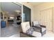 Comfortable screened patio featuring cozy seating and an open view to the modern kitchen and living area at 8417 Karpeal Dr # 4, Sarasota, FL 34238