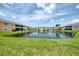 Beautiful condo community with a tranquil pond view and lush green lawns at 8417 Karpeal Dr # 4, Sarasota, FL 34238