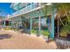 Charming storefront with bright turquoise exterior, flower-filled planters, and inviting sidewalk appeal at 8417 Karpeal Dr # 4, Sarasota, FL 34238