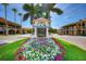Welcome to Venice sign with lush flower bed surrounded by palm trees on a clear sunny day at 8417 Karpeal Dr # 4, Sarasota, FL 34238
