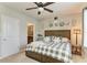Comfortable bedroom featuring a ceiling fan, a queen bed, and decorated wall art at 8676 Ice Wine St, Sarasota, FL 34238
