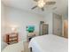 Bright bedroom with a ceiling fan, television on console, and a closet at 8676 Ice Wine St, Sarasota, FL 34238