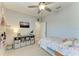 Bedroom featuring a cute single bed, shelving, a TV and natural light from the window at 8676 Ice Wine St, Sarasota, FL 34238