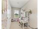 This room has a white desk and chair set, with light grey walls and plush decoration at 8676 Ice Wine St, Sarasota, FL 34238