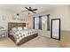 Comfortable bedroom with a ceiling fan, a large bed, and natural light from the windows at 8676 Ice Wine St, Sarasota, FL 34238