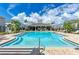 Community pool with crystal-clear water, sun loungers, and a clubhouse for residents at 8676 Ice Wine St, Sarasota, FL 34238