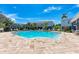 Community pool with ample seating and landscaping, ideal for relaxation and socializing at 8676 Ice Wine St, Sarasota, FL 34238
