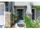 Stylish front entrance with stone accents, a black door, and lush landscaping at 8676 Ice Wine St, Sarasota, FL 34238