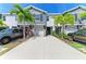 Townhome with well-maintained front yard, beautiful palm trees, and ample driveway parking at 8676 Ice Wine St, Sarasota, FL 34238