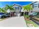 Charming townhome with a well-manicured lawn, lush landscaping, and a driveway with two cars at 8676 Ice Wine St, Sarasota, FL 34238