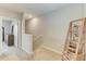 Bright hallway with carpet and decorative wooden ladder shelf on the upper level at 8676 Ice Wine St, Sarasota, FL 34238
