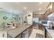 Open-concept kitchen with granite island, stainless appliances, and dining area at 8676 Ice Wine St, Sarasota, FL 34238