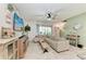 Bright living room with large TV, comfortable seating, and access to the patio at 8676 Ice Wine St, Sarasota, FL 34238