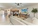 Open-concept living room with kitchen view and comfortable seating area at 8676 Ice Wine St, Sarasota, FL 34238