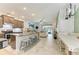 Open-concept living space with a kitchen island, and a view to the outdoor living area at 8676 Ice Wine St, Sarasota, FL 34238