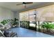 Covered patio featuring outdoor seating, potted plants, and views of the backyard at 8676 Ice Wine St, Sarasota, FL 34238