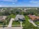 Beautifully landscaped property with a circular driveway, lush lawn, and a view of the lake at 8924 Misty Creek Dr, Sarasota, FL 34241