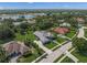 An aerial view of a home with a screened-in pool and beautiful landscaping in a serene neighborhood at 8924 Misty Creek Dr, Sarasota, FL 34241