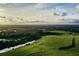Expansive aerial view of lush green landscapes, meandering waterways, and scenic beauty, highlighting the natural surroundings at 8924 Misty Creek Dr, Sarasota, FL 34241