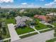 Aerial view of home, showcasing lush landscaping, tile roof and long driveway at 8924 Misty Creek Dr, Sarasota, FL 34241