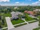 Aerial view of home, showcasing lush landscaping, tile roof and long driveway at 8924 Misty Creek Dr, Sarasota, FL 34241